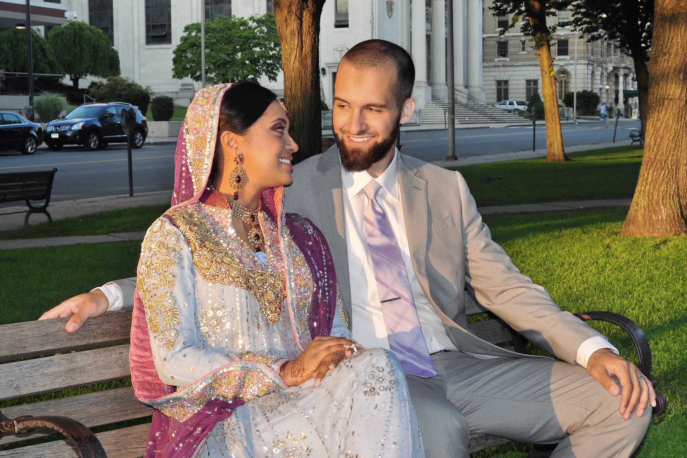 Newlywed couple sharing a warm look on a park bench during an intimate Tampa Bay elopement portrait photography session.