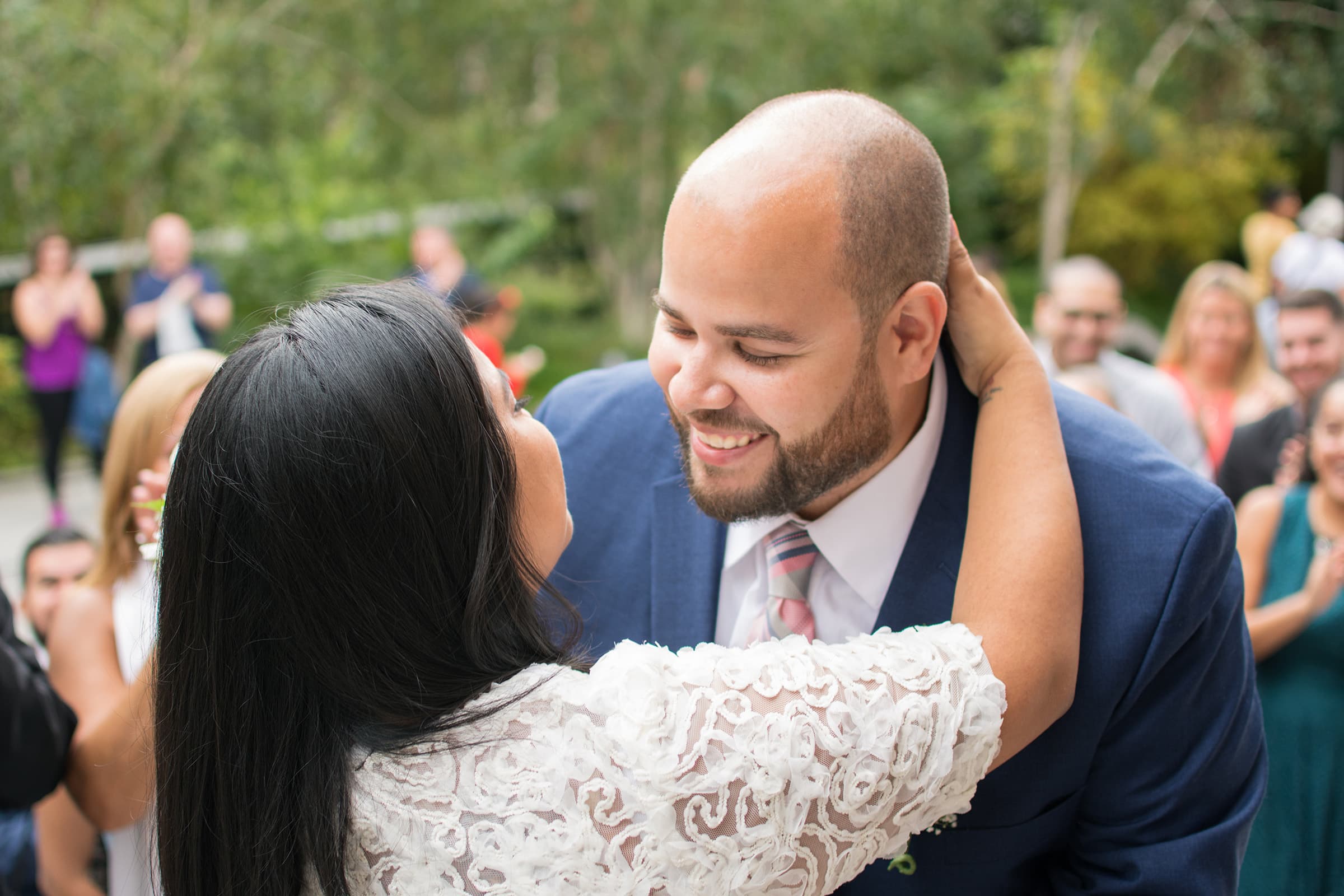 Newlywed couple embracing and smiling after an intimate outdoor ceremony, photographed during a Tampa Bay elopement session.