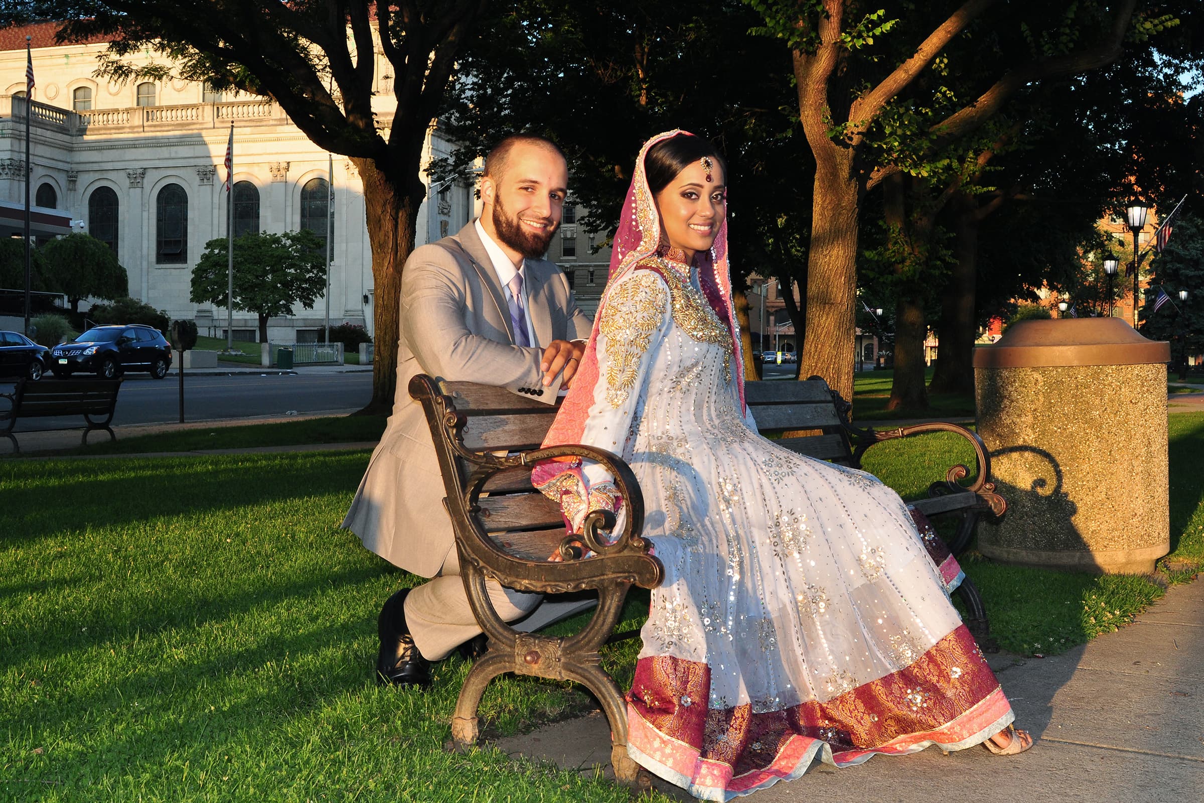 Newlywed couple in traditional wedding attire posing outdoors during a Tampa Bay elopement portrait session at golden hour.