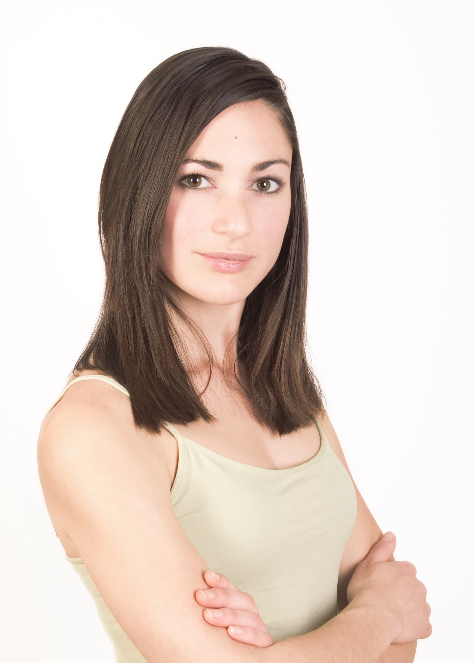 Professional studio portrait of a woman with folded arms against a bright white background for Tampa business branding.